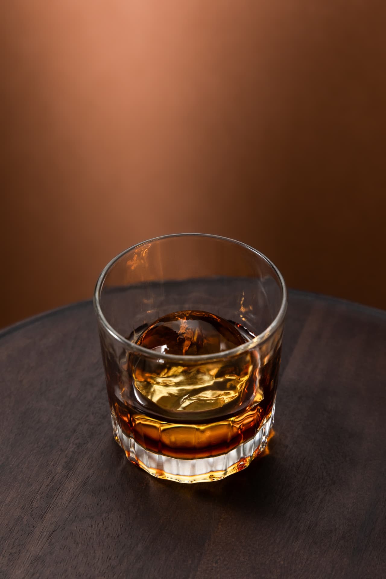 Ice sphere served in a glass of whisky