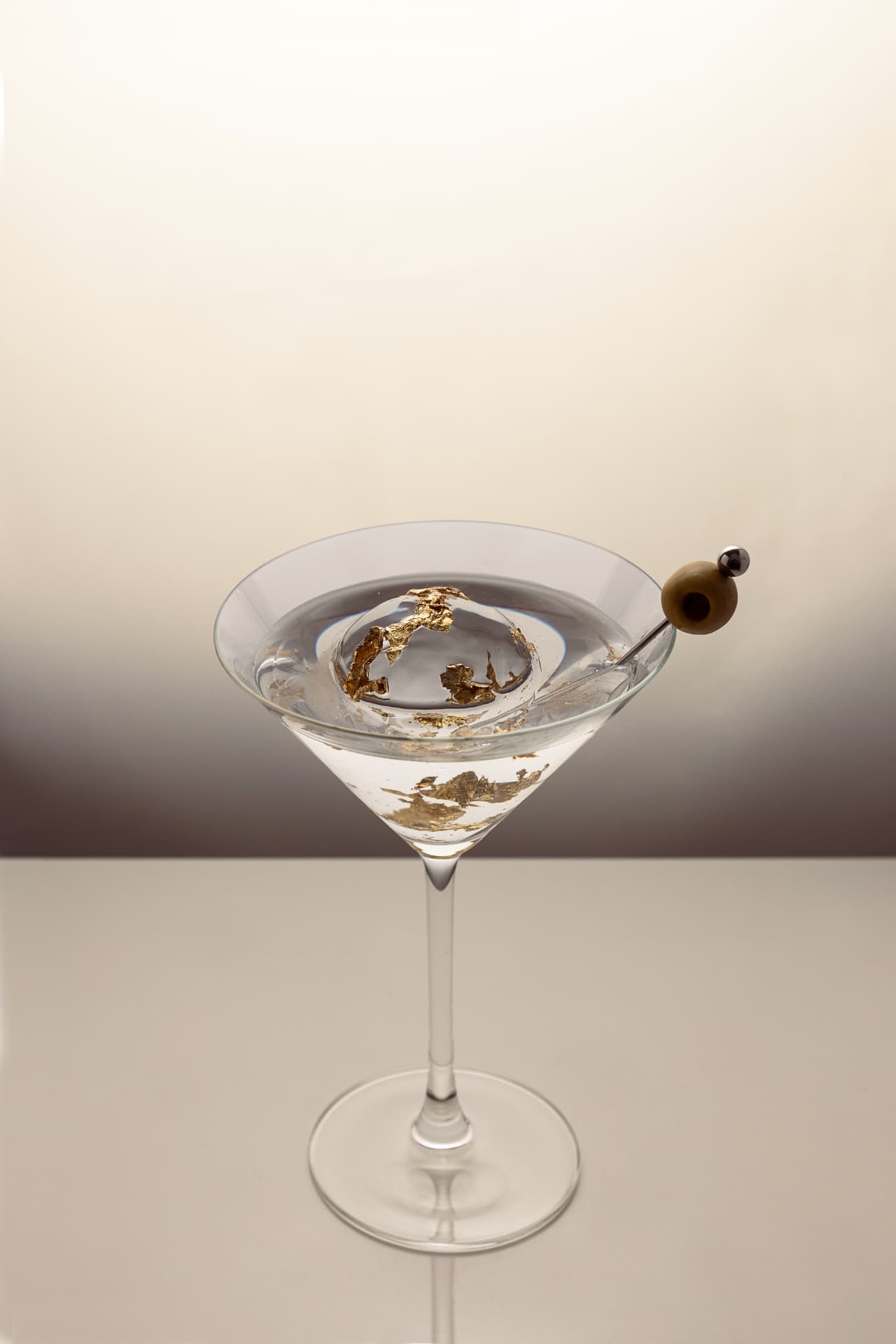 Prestige ice sphere with gold leaf in a stemmed glass