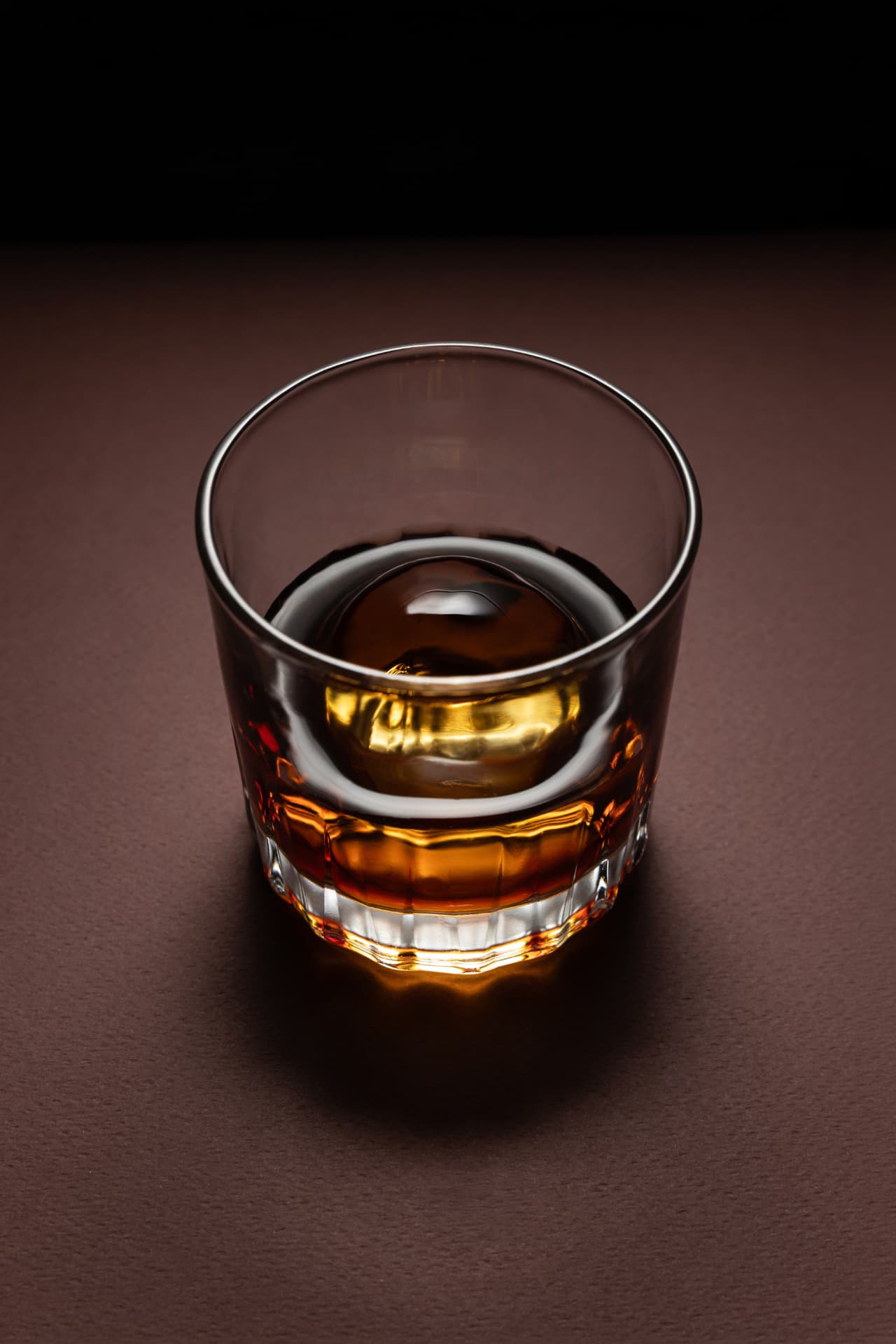 Pure Signature ice sphere in a glass of whisky